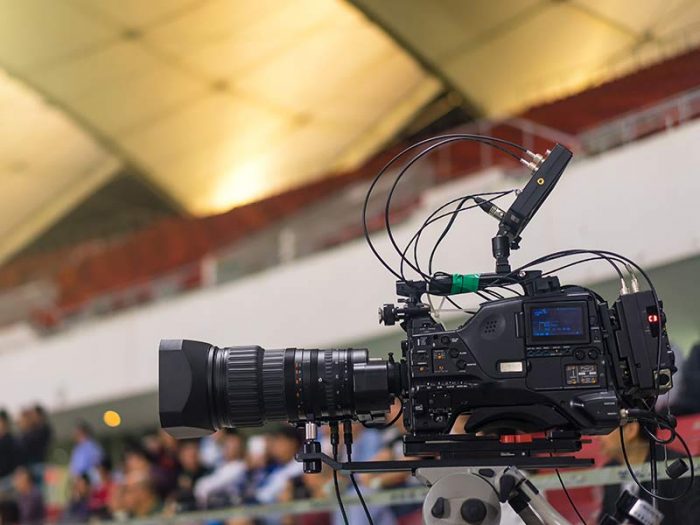Video camera filming at large sports events.