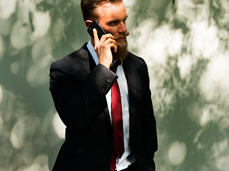 phone call made outside by man in suit