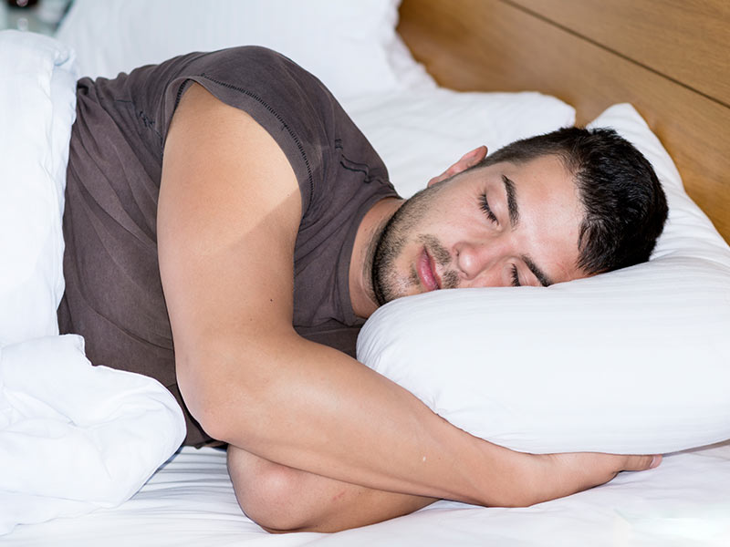 picture of a man sleeping in bed