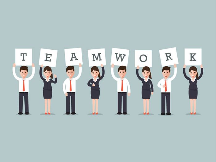 employees holding up teamwork